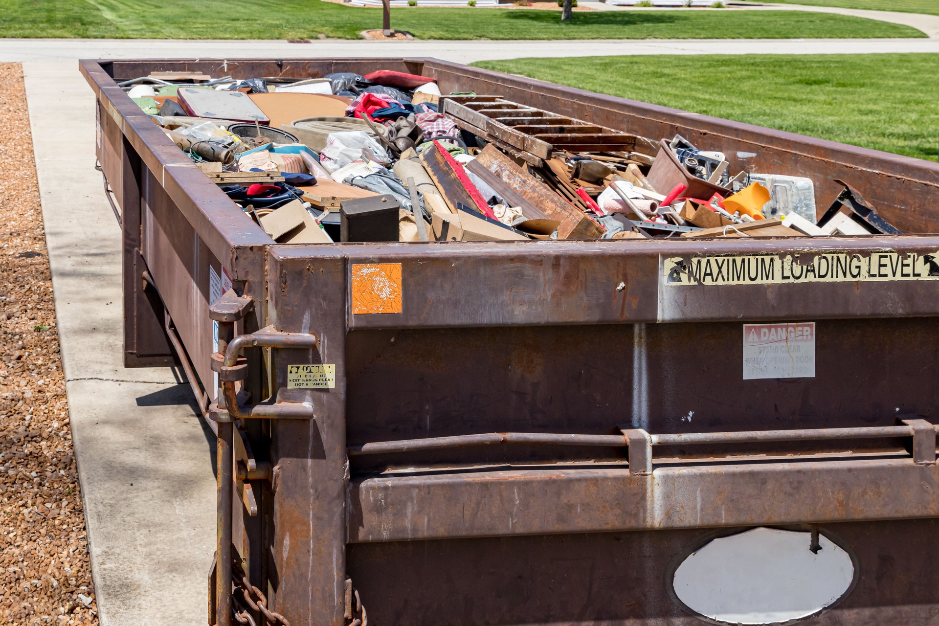 Garbage, trash or waste dumpster full of household junk. Concept of cleaning, cleanup, hoarding and disposal.