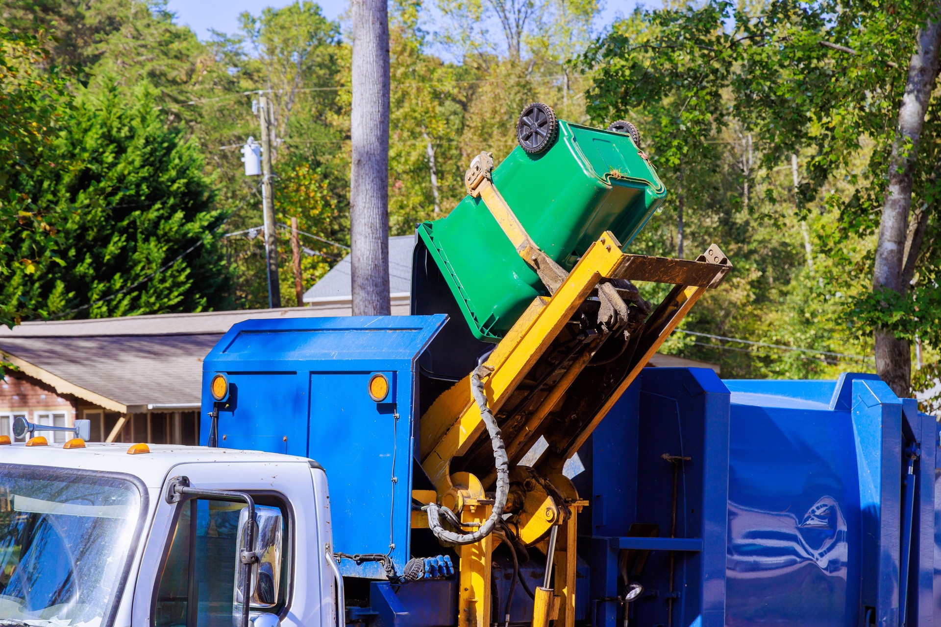 Municipal cleaning service removal garbage by means of loading mixed domestic waste to a garbage truck